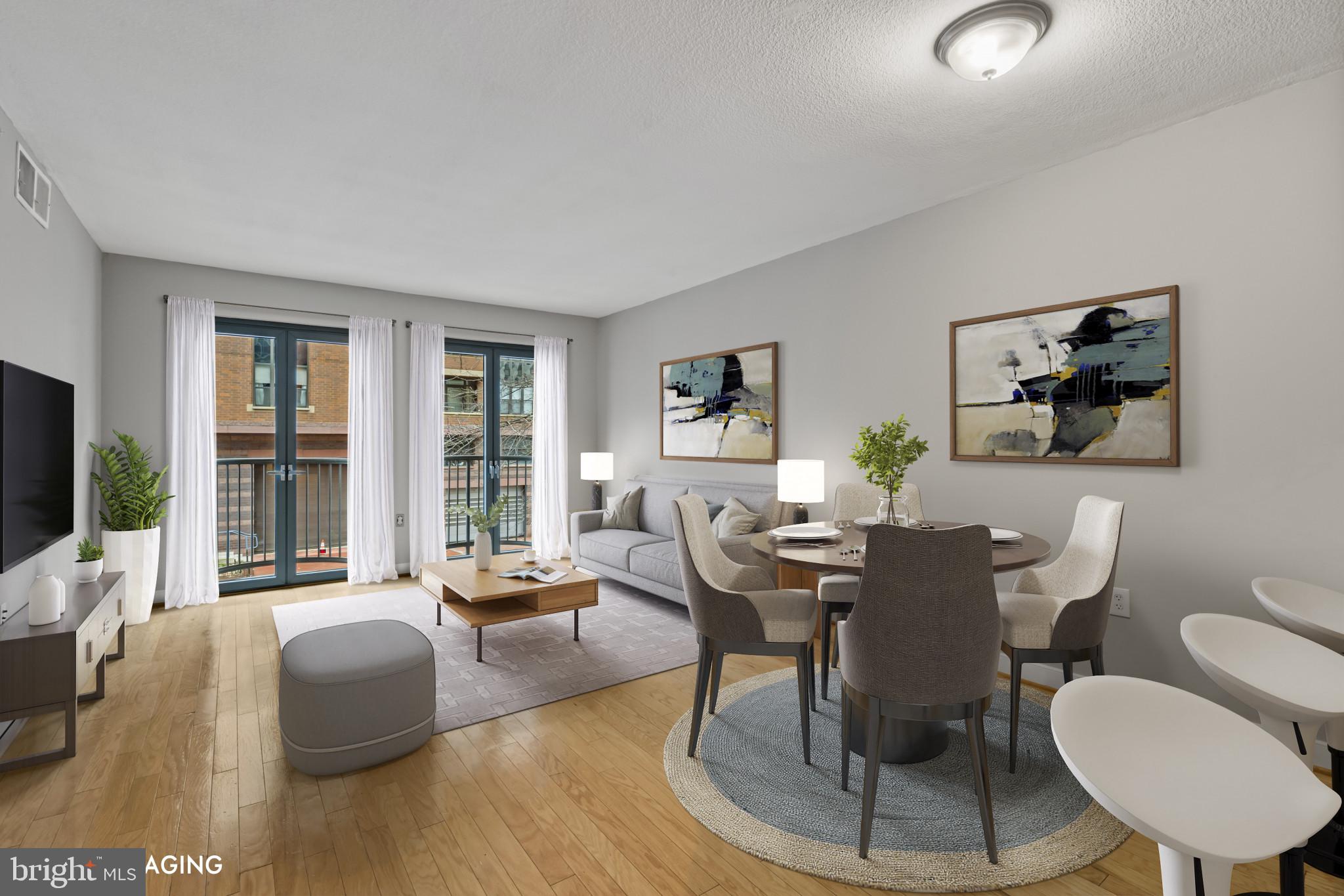 1117 10th Street Northwest, Unit 202 Washington, DC 20001 - Photo 4 of 29 a dining room with furniture a large window and a flat screen tv