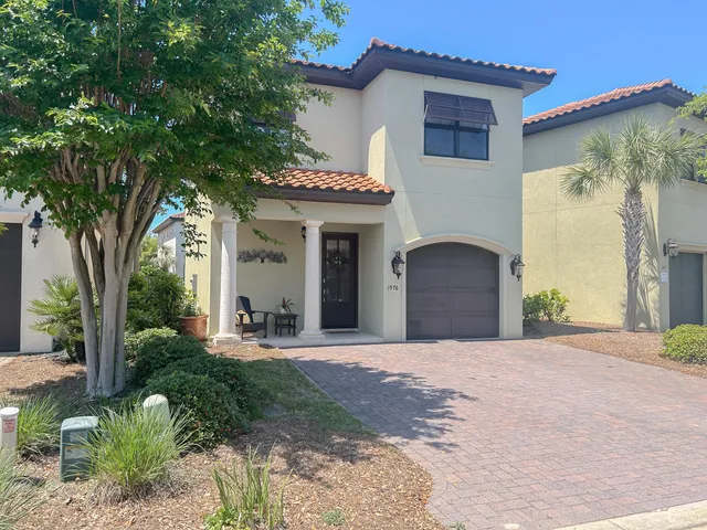 a front view of a house with a yard and a garage