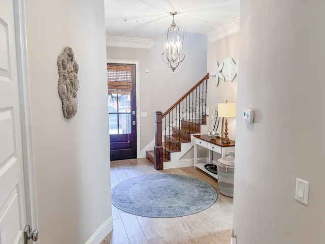 a view of entryway livingroom and hall with wooden floor