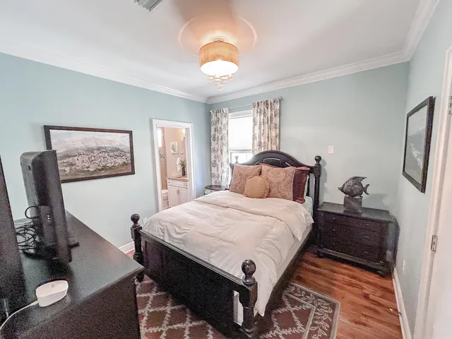 a bedroom with a bed and a chandelier