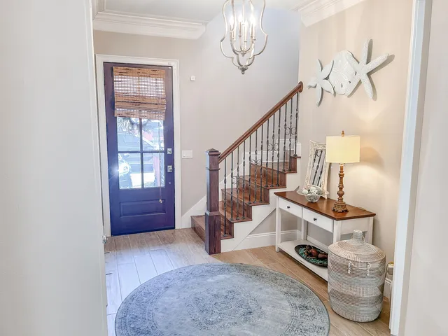 a view of entryway livingroom and hall with wooden floor