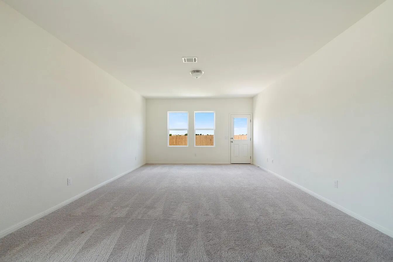101 Aoudad Road Hutto, TX 78634 - Photo 22 of 39 A spacious, naturally illuminated room featuring plush carpeting and backyard access.