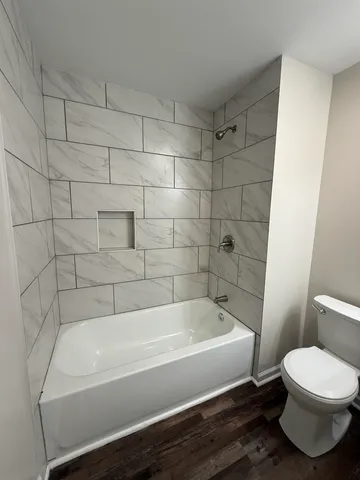 a bathroom with a bathtub and toilet