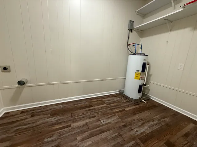 a view of a room with wooden floor and a window