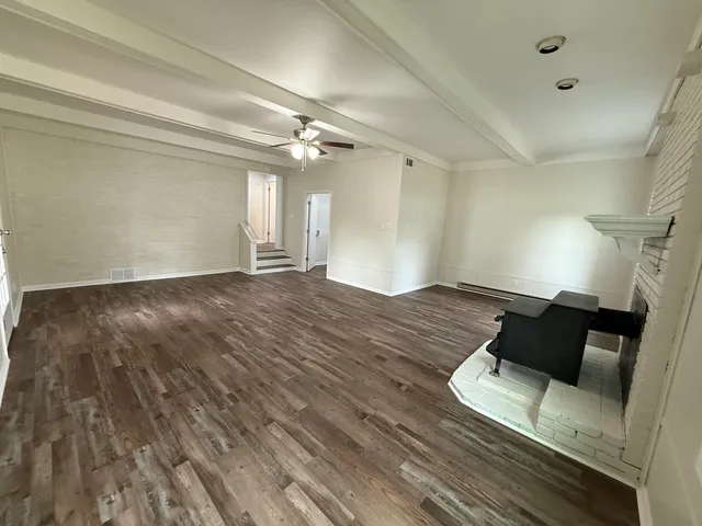 a view of a room with wooden floor