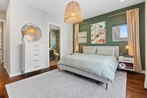 a bedroom with a bed and a mirror