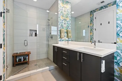 a spacious bathroom with a sink a double vanity and a mirror