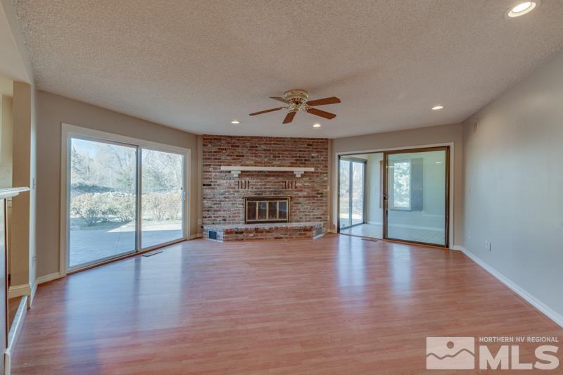 1860 Wendy Way Reno, NV 89509 - Photo 13 of 36 a view of an empty room with a window and wooden floor