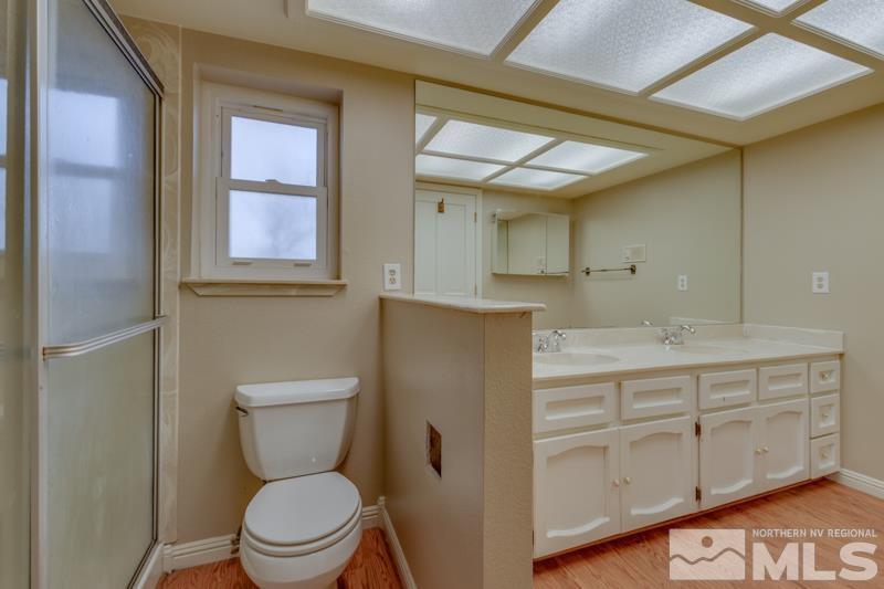 1860 Wendy Way Reno, NV 89509 - Photo 17 of 36 a bathroom with a toilet sink vanity and granite
