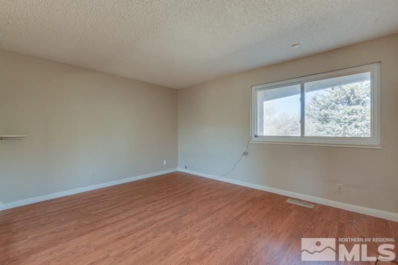 1860 Wendy Way Reno, NV 89509 - Photo 18 of 36 an empty room with wooden floor and windows