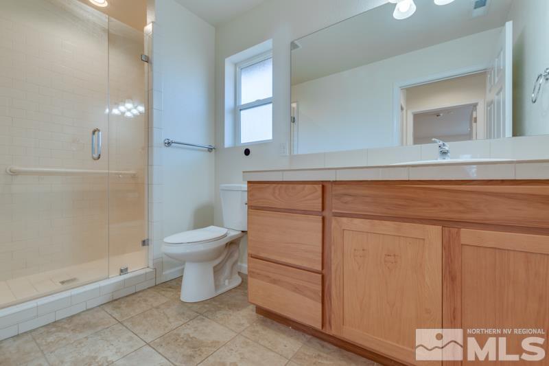 1860 Wendy Way Reno, NV 89509 - Photo 25 of 36 a bathroom with a toilet a sink and mirror