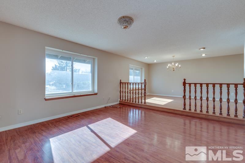 1860 Wendy Way Reno, NV 89509 - Photo 5 of 36 a view of an empty room with a window and wooden floor