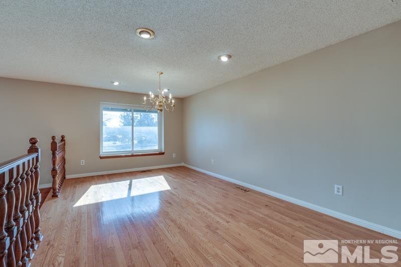 1860 Wendy Way Reno, NV 89509 - Photo 7 of 36 an empty room with wooden floor and windows