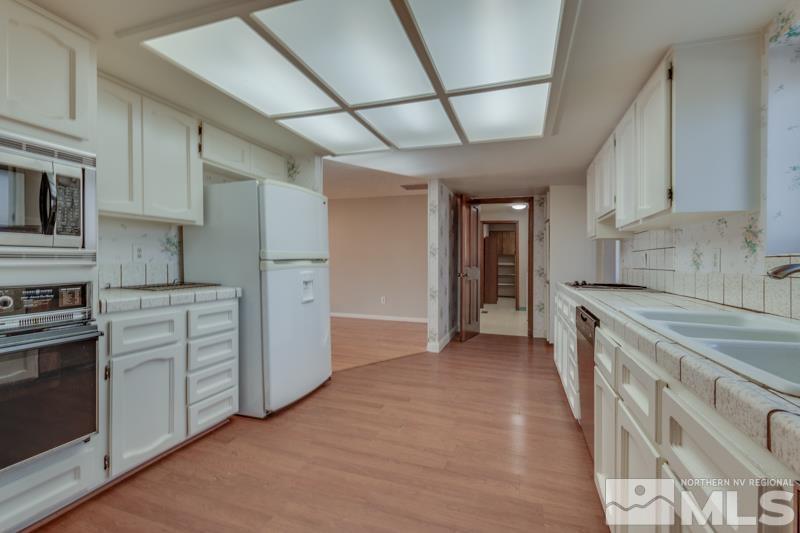 1860 Wendy Way Reno, NV 89509 - Photo 8 of 36 a kitchen with stainless steel appliances granite countertop a sink and cabinets
