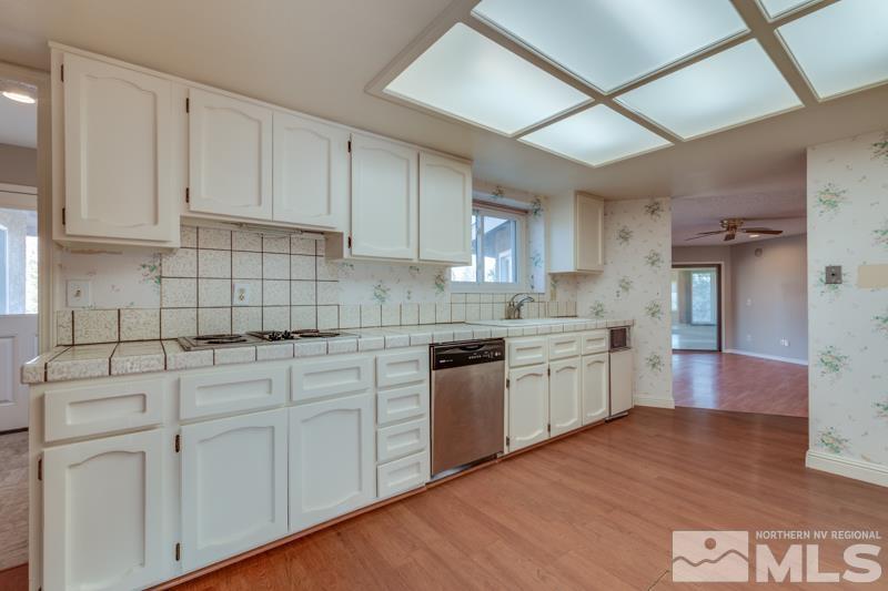 1860 Wendy Way Reno, NV 89509 - Photo 9 of 36 a kitchen with granite countertop white cabinets and white appliances