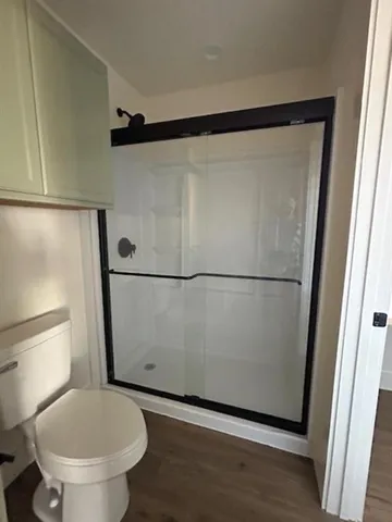 a bathroom with a toilet and a shower