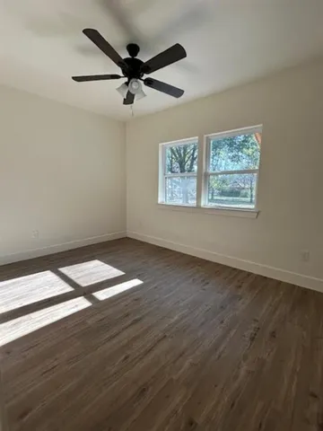 a view of a room with wooden floor and staircase