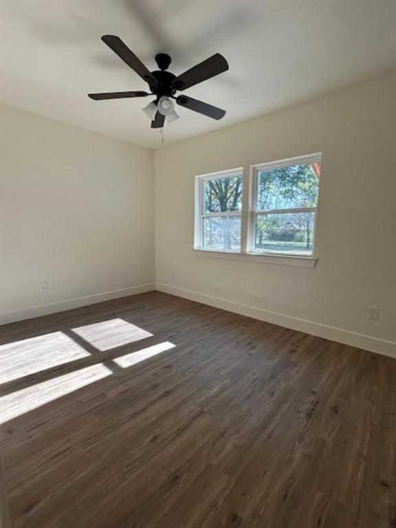 415 West Walnut Street Whitewright, TX 75491 - Photo 27 of 36 an empty room with wooden floor fan and windows