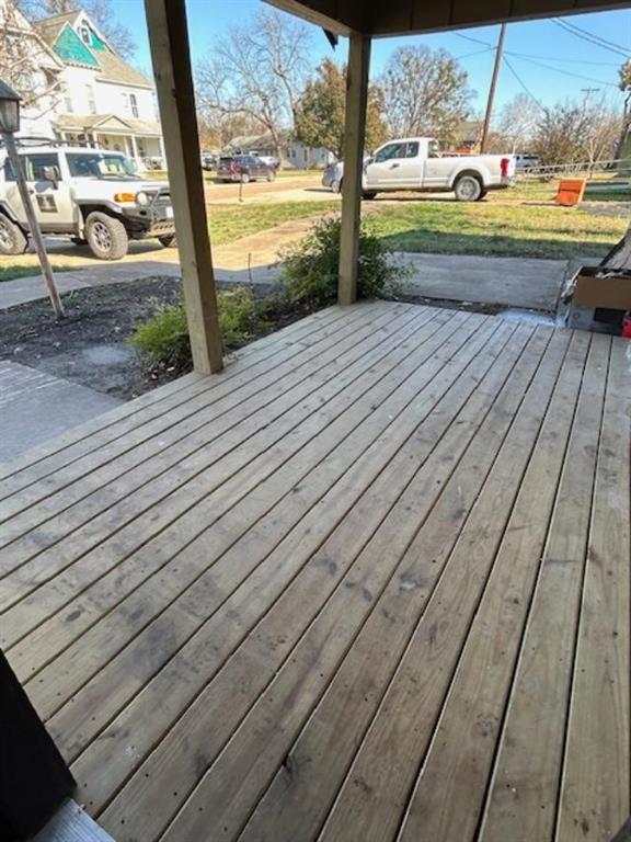 415 West Walnut Street Whitewright, TX 75491 - Photo 34 of 36 a view of roof deck with wooden floor and fence