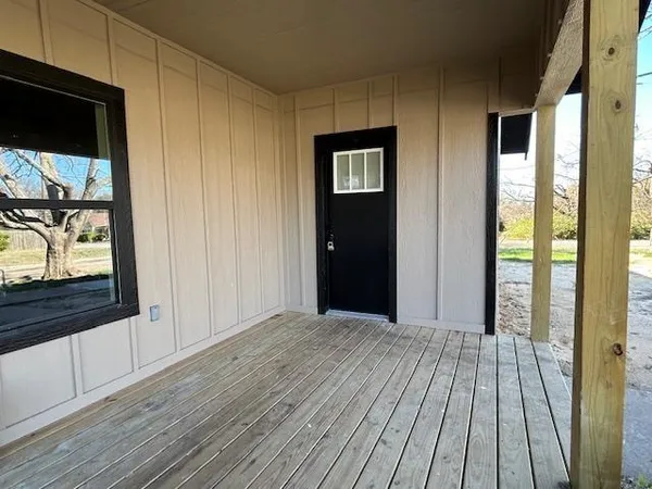 a view of a room with wooden floor and doors