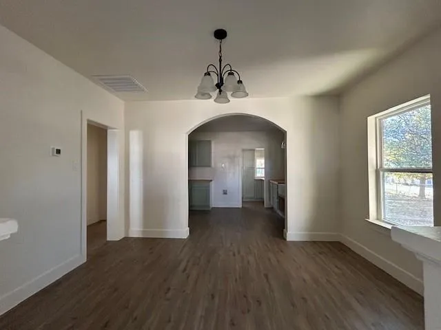 a view of a room with wooden floors