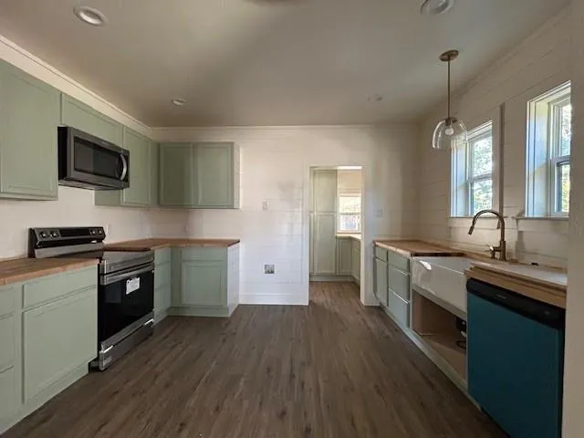 a kitchen with a sink stove and microwave