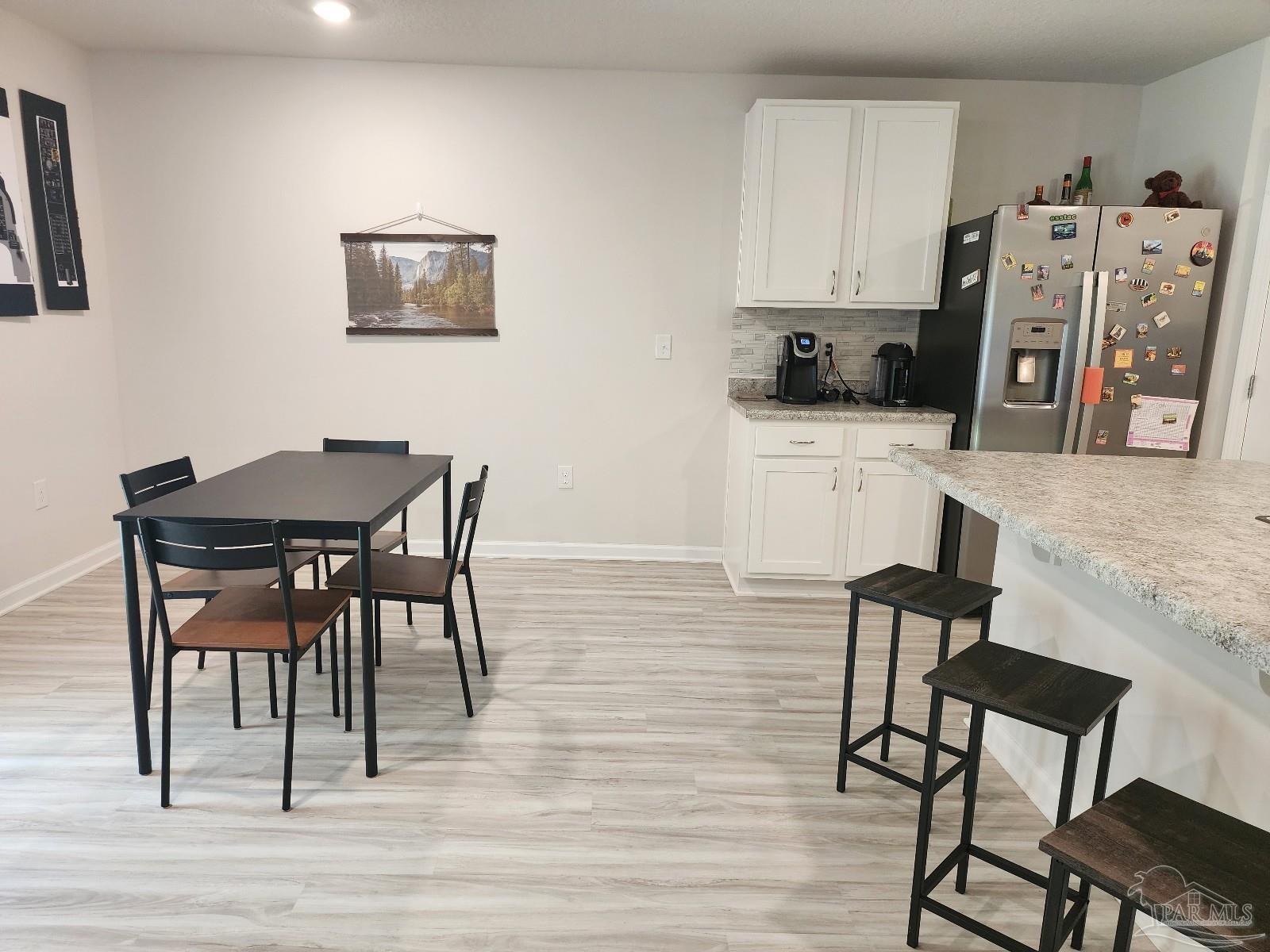 5379 Peach Drive Pace, FL 32571 - Photo 11 of 23 a view of a dining room with furniture and wooden floor