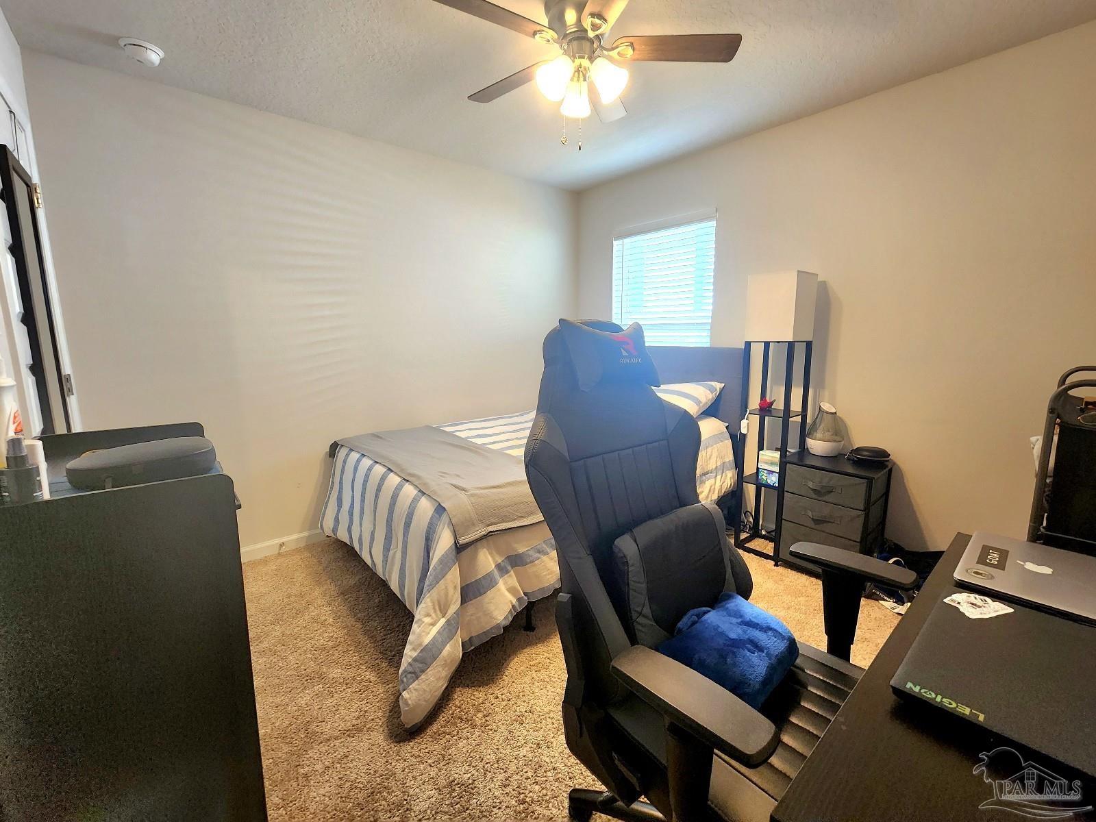 5379 Peach Drive Pace, FL 32571 - Photo 14 of 23 a living room with furniture and a chandelier