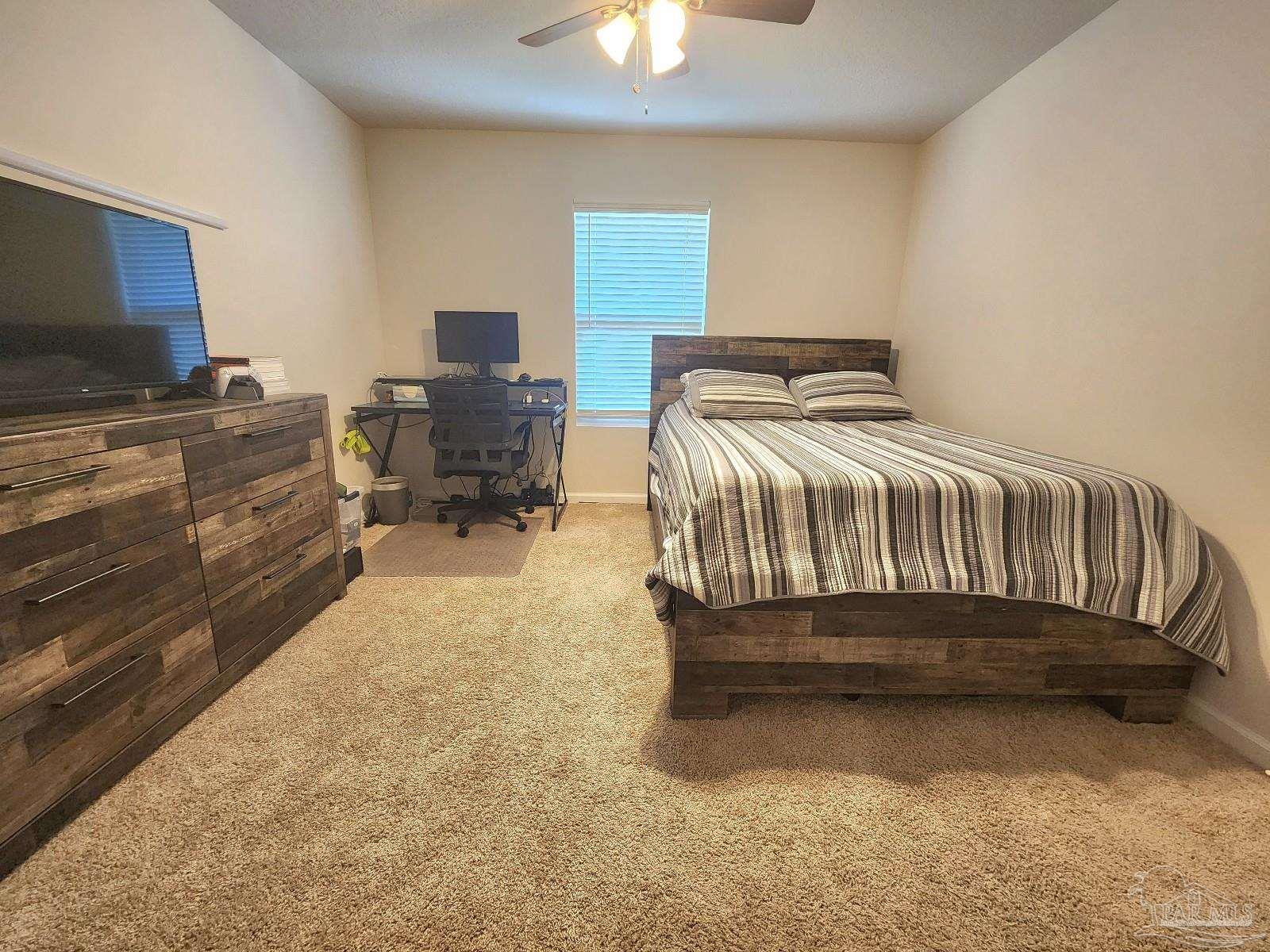 5379 Peach Drive Pace, FL 32571 - Photo 16 of 23 a bedroom with a bed and furniture