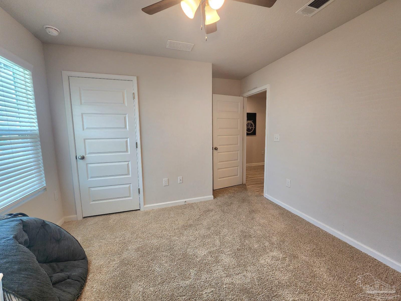 5379 Peach Drive Pace, FL 32571 - Photo 18 of 23 an empty room with a ceiling fan