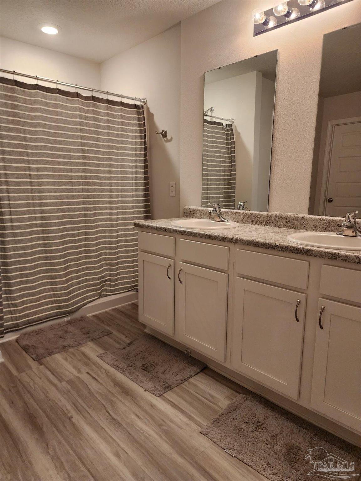 5379 Peach Drive Pace, FL 32571 - Photo 19 of 23 a bathroom with a sink and a mirror