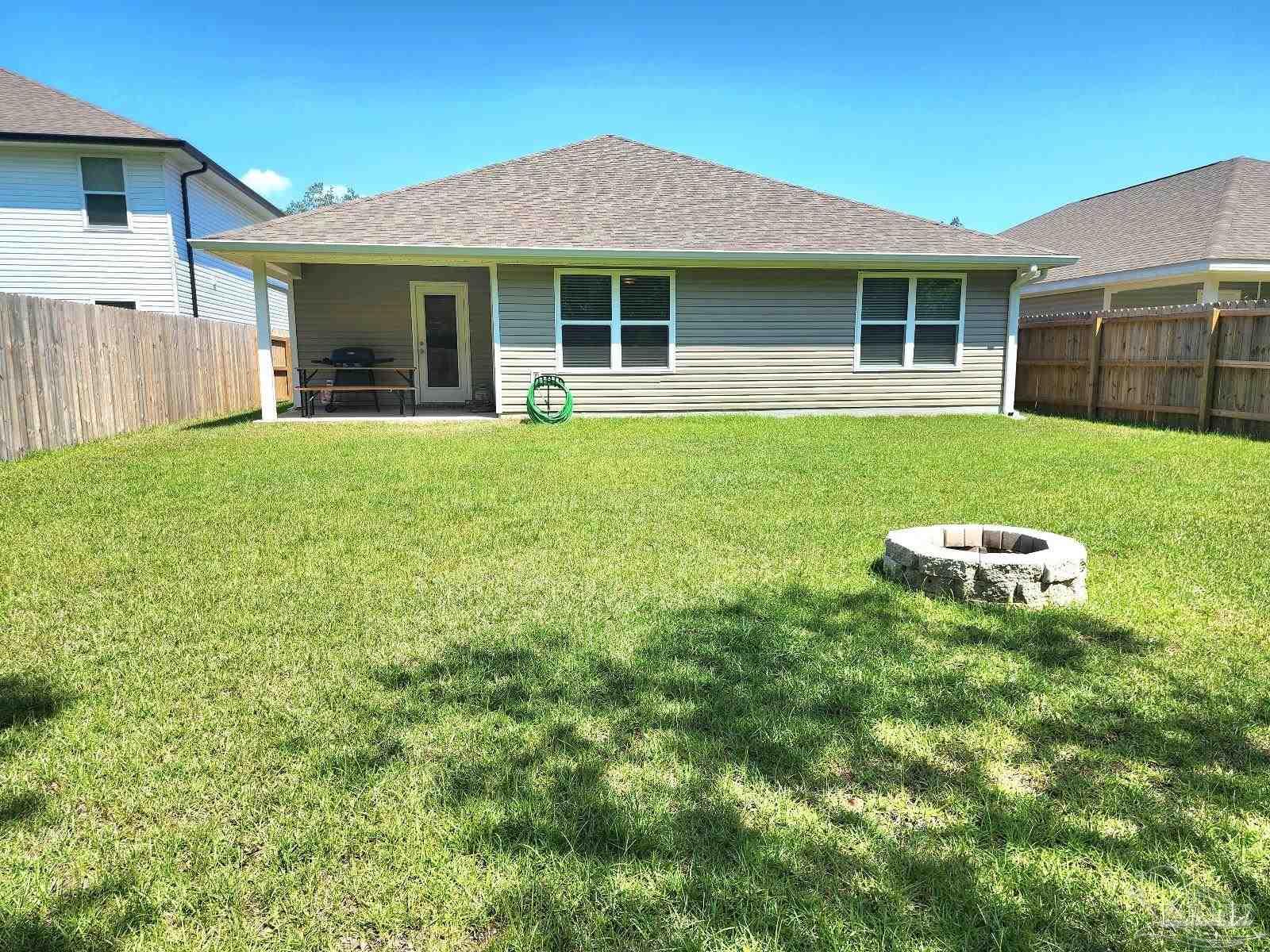 5379 Peach Drive Pace, FL 32571 - Photo 22 of 23 a view of a house with a yard and sitting area