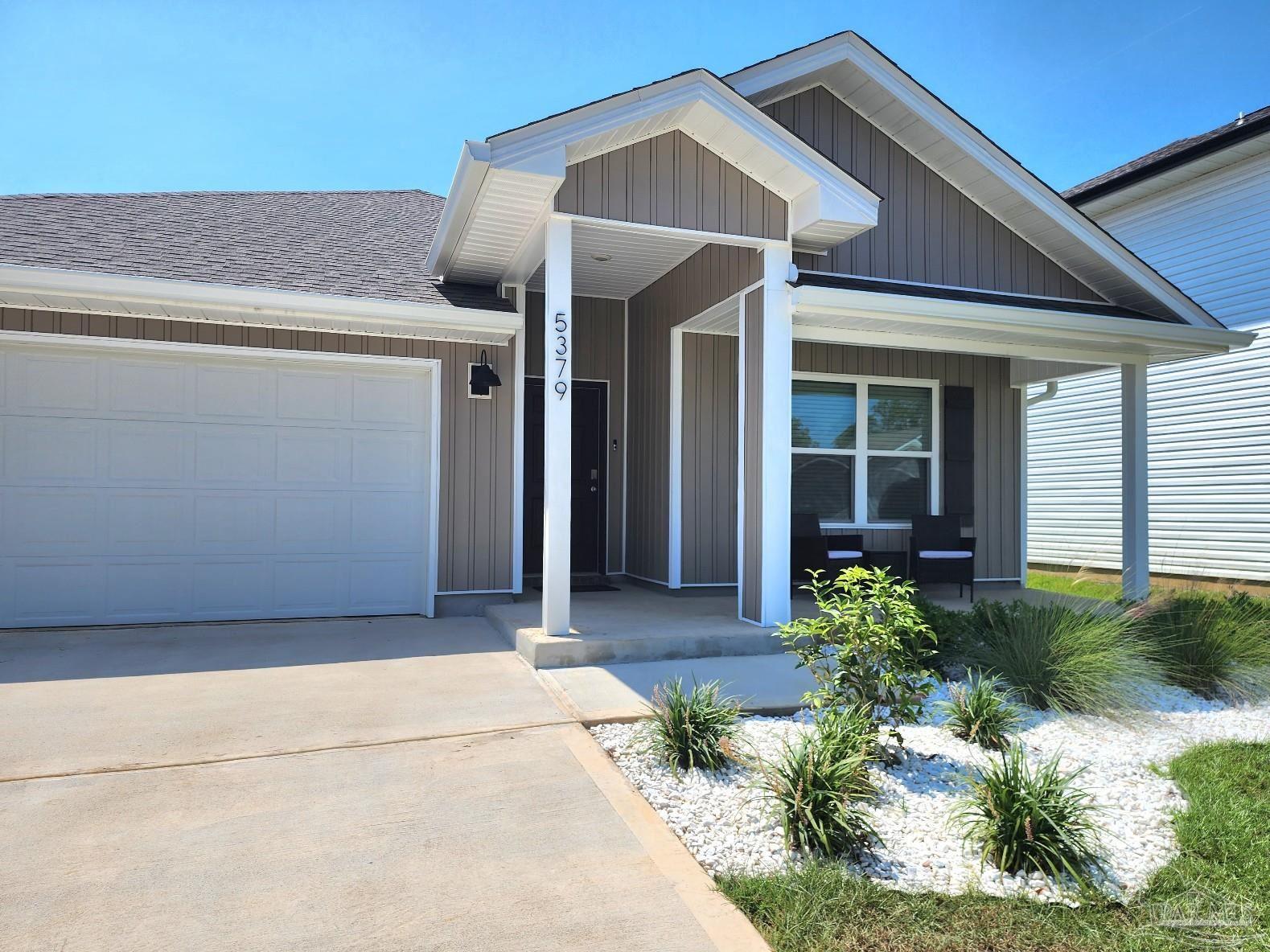 5379 Peach Drive Pace, FL 32571 - Photo 3 of 23 a view of a house with potted plants