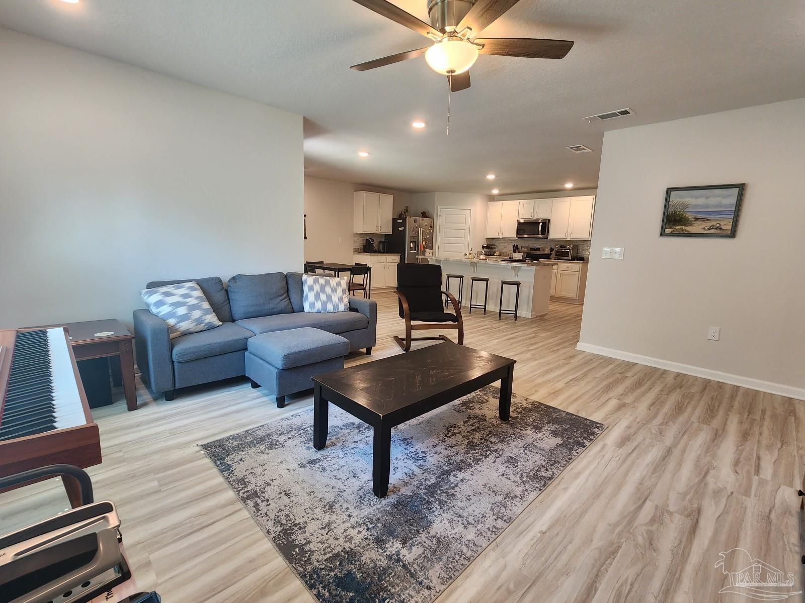 5379 Peach Drive Pace, FL 32571 - Photo 7 of 23 a living room with furniture and a rug