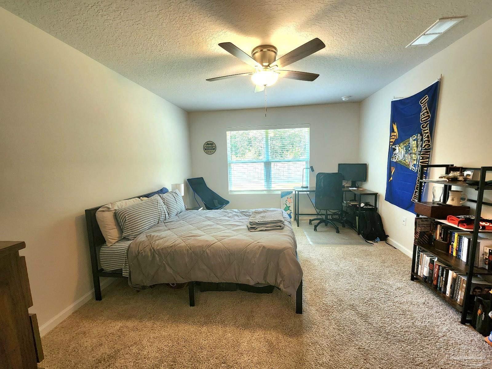 5379 Peach Drive Pace, FL 32571 - Photo 10 of 23 a bed room with a bed and a large window