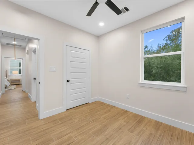 wooden floor in an empty room with a window