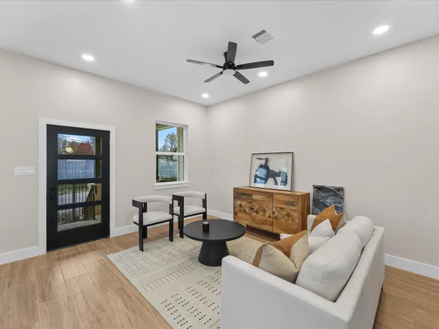 a living room with furniture and a wooden floor