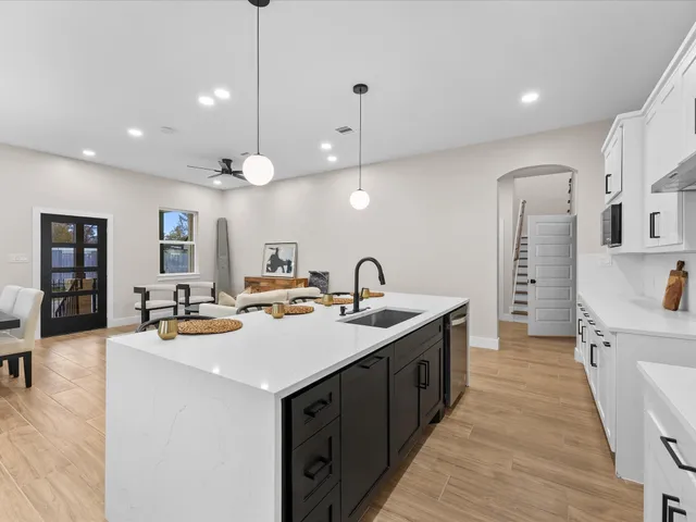 a kitchen with sink stove and cabinets