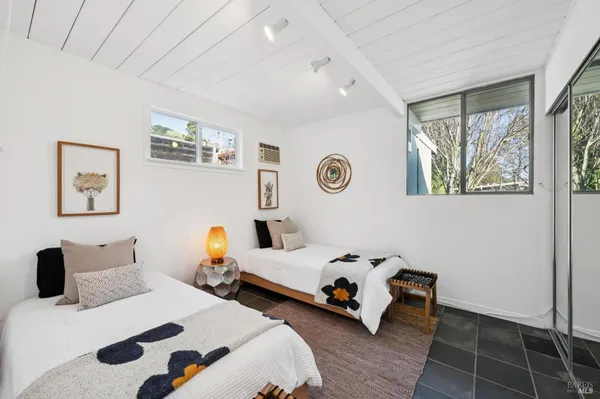 a bedroom with two beds and a window