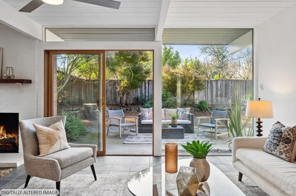 a view of a patio with couches table and chairs and potted plants