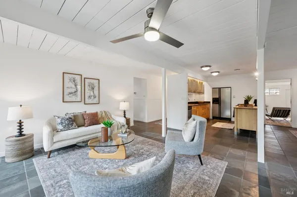 a living room with furniture and kitchen view
