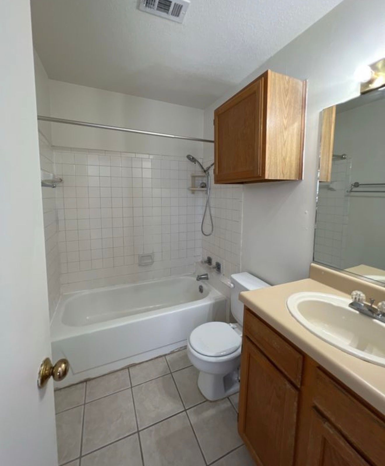 3115 Helms Street, Unit 111 Austin, TX 78705 - Photo 7 of 13 A compact bathroom offers essential functionality with a tub/shower combination and vanity.