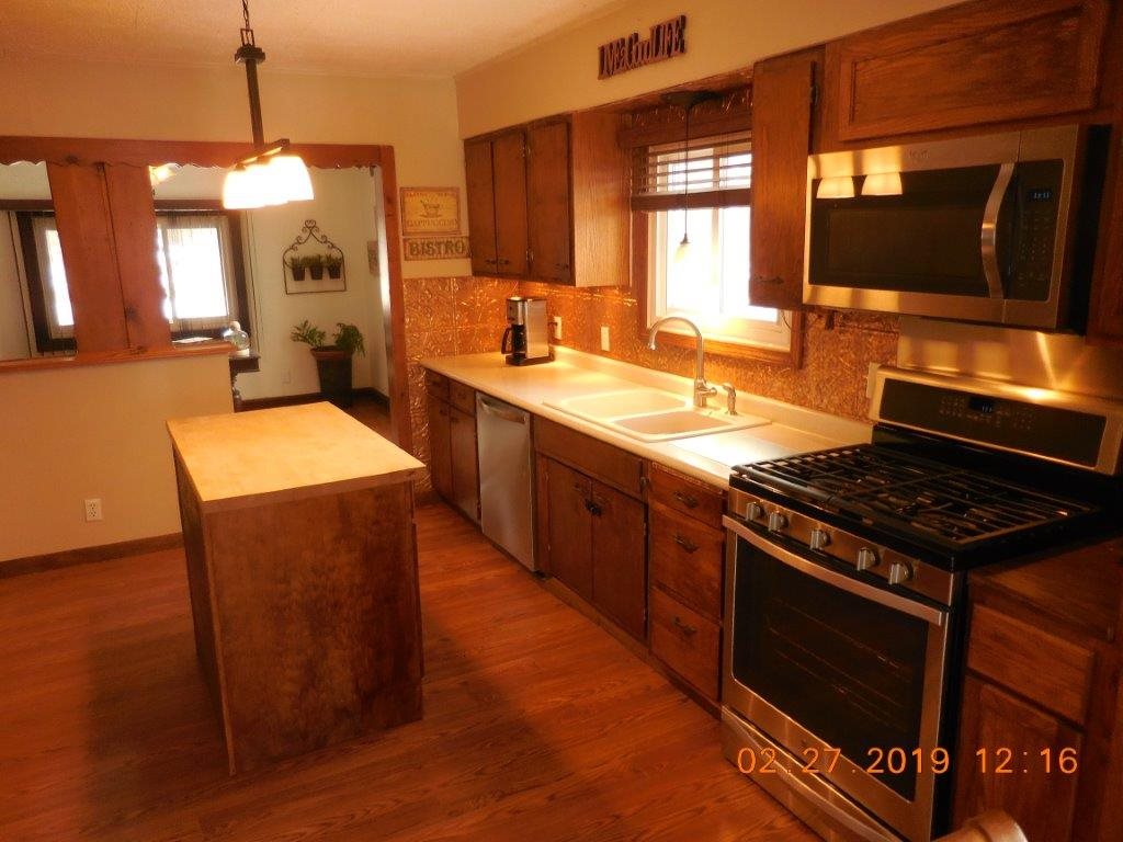 4483 Centerville Road Rockford, IL 61102 - Photo 12 of 24 a kitchen with stainless steel appliances granite countertop a stove a sink and a microwave