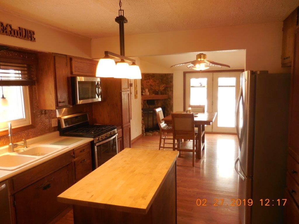 4483 Centerville Road Rockford, IL 61102 - Photo 13 of 24 a kitchen with a table chairs and a chandelier