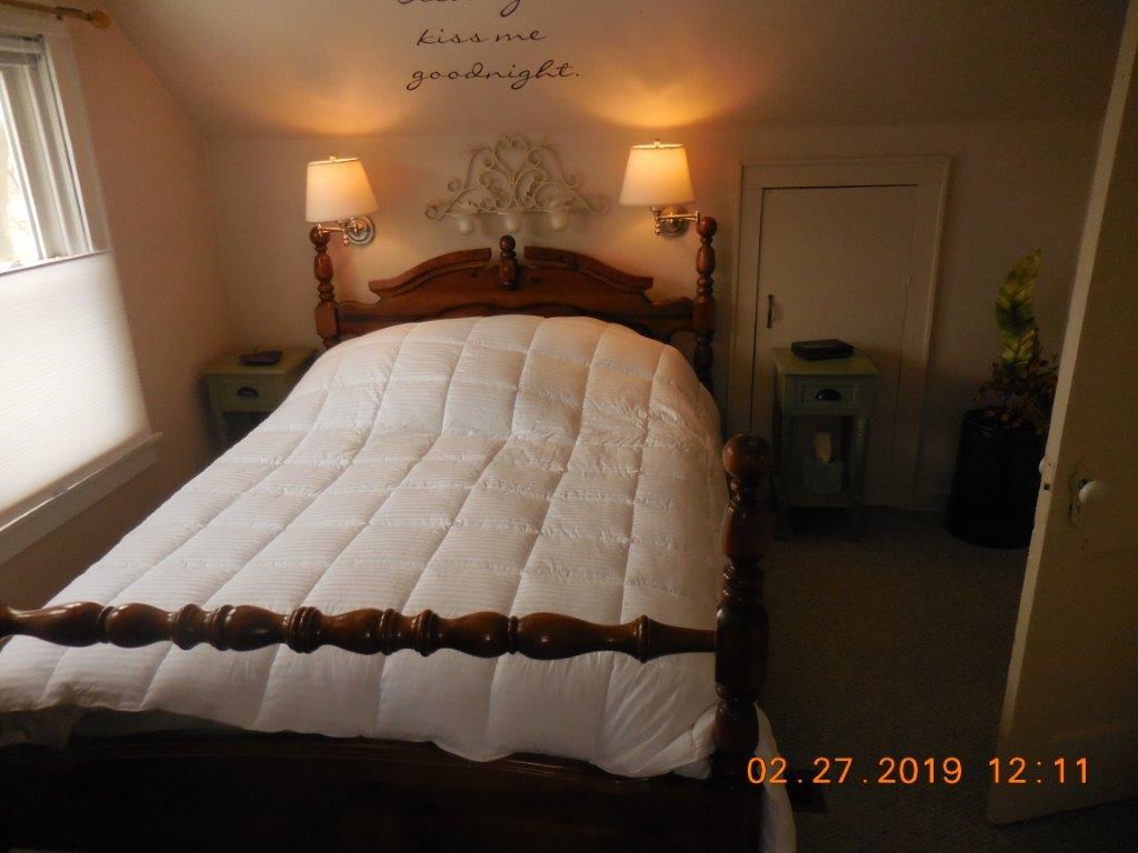 4483 Centerville Road Rockford, IL 61102 - Photo 18 of 24 a bed sitting in a bedroom next to a window