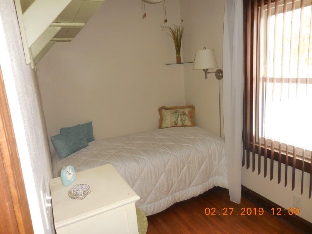 4483 Centerville Road Rockford, IL 61102 - Photo 19 of 24 a bedroom with a bed and wooden floor