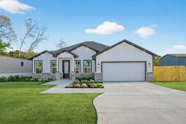 a front view of a house with garden