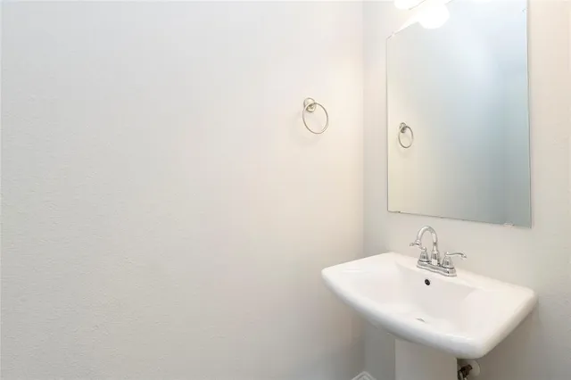 a view of a kitchen with a sink and a refrigerator