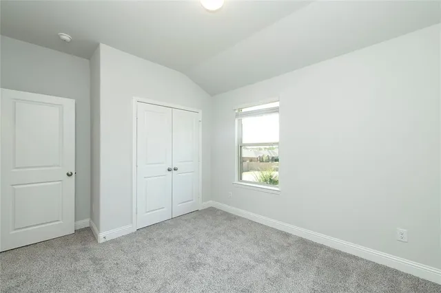 a bathroom with a granite countertop sink toilet a mirror and shower