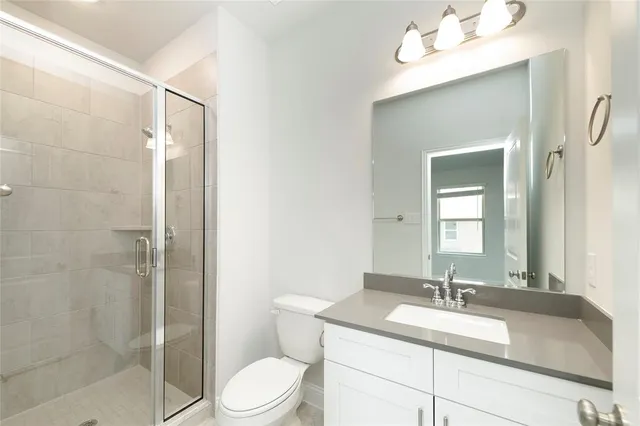 a swimming pool with some plants and large tree